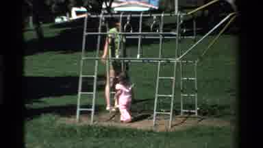 California USA (1979): Child Plays Outside At A Park On Old Metal Structure