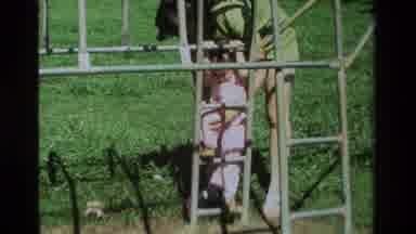 California USA (1979): Lady In Green Shirt Teaching Young Daughter How To Climb A