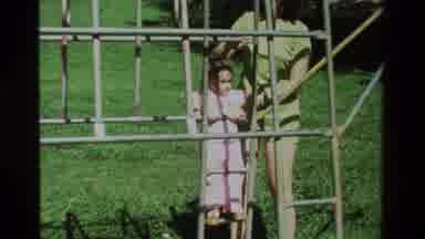 California USA (1979): A Little Girl And Adult Woman By A Set Of Monkey Bars