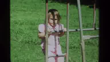 California USA (1979): Little Girl In Pink Top Climbs Ladder For First Time