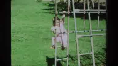California USA (1979): Little Girl In Pink Jumpsuit Climbing A Jungle Gym