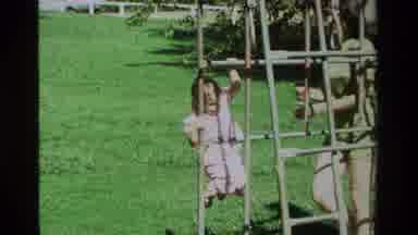California USA (1979): Little Girl Gets Stuck On A Bar As Her Mother Comes Over To
