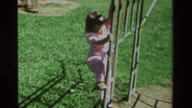 California USA (1979): Girl Climbing In The Park With An Adults Help