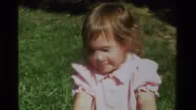 California USA (1979): A Little Girl In A Pink Dress Running Up To Her Mom To Put
