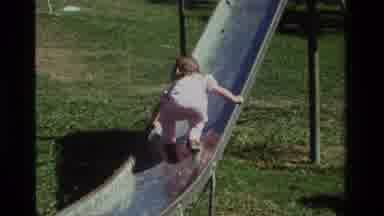 California USA (1979): A Child Is Playing On Slider With Her Mom And Enjoying The