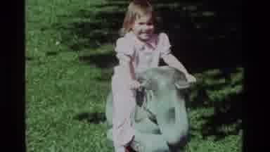California USA (1979): Baby Riding Elephant Bouncer Toy At The Park In The Spring