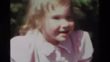 California USA (1979): A Girl With Pink Clothes Is Happily Standing On The