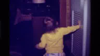 California USA (1979): Small Child In A Yellow Long Sleeve Shirt And Colorful