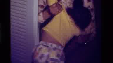 California USA (1979): Mother Removing Upset Child From Closet And Snuggling To