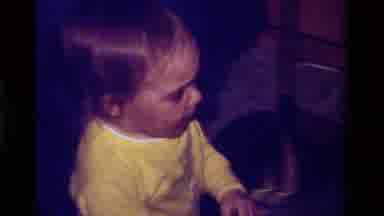 California USA (1979): Baby Running In House Holding Finger Gets Stopped In