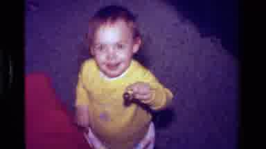California USA (1979): A Cute Little Boy Surprised At Finding A Ball And Filled