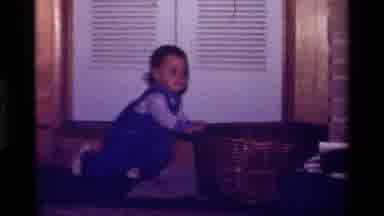 California USA (1979): A Little Girl Playing On Living Room Shelf