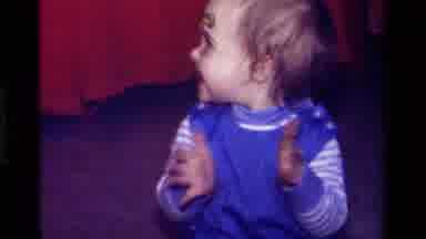 California USA (1979): Excited Child Clapping After Completing Stacking Colored