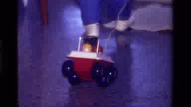 CALIFORNIA USA-1979: Toddler Pulling Red Toy Car Behind Him As He Walks