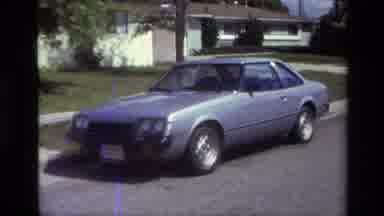 Laguna Beach California USA (1979): A Blue Car Sitting Curbside In Front Of Some