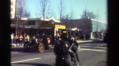 California USA-1981: Parade With A Classic Car Moving Down The Street And A