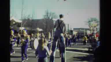 California USA (1981): Person On Stilts Walking Through Crowded Parade Beside