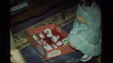 California USA (1981): Girl In Blue Dress Opening Presents With Her Family On