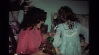 California USA (1981): Family Opening Presents On A Holiday Wearing Clothes From