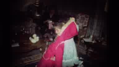 California USA (1981): Girl In Living Room With Her Parents Unwrapping And Trying