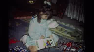 California USA (1981): Little Girl Opens Toys While Other Wrapped Gifts Surrounds