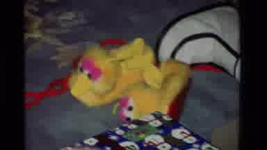 California USA (1981): Lady Opening A Gift In Her Living Room That Contains Big