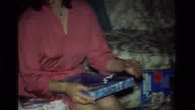 California USA (1981): One Lady And Two Childrens Are Opening The Gift Box With
