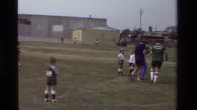 California USA (1981): A Man In A Blue Shirt Carrying A Kid Off A Field
