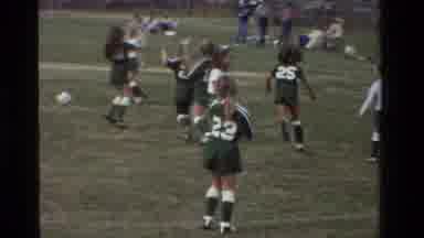 California USA (1981): Young Girls In Green Soccer Uniforms Playing Soccer On A