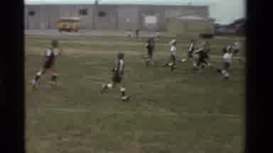 California USA (1981): Little Kids Playing Soccer On A Green Field In The