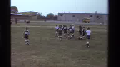 California USA (1981): Kids Playing Soccer On A Sports Field In A Small Stadium