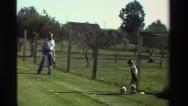 California USA (1981): A Father And Daughter Play Football Together On The Grass