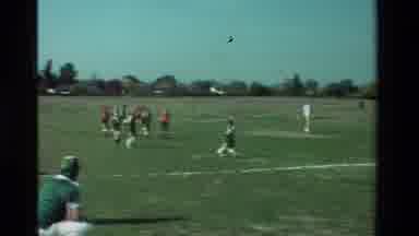 California USA (1981): Kids Football Match Grass Orange And Green Teams Referee