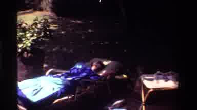California USA (1981): A Young Child Laying In A Prone Position In The Shade
