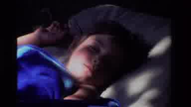 California USA (1981): Zooming In And Out On A Child While They Sleep With Shadows