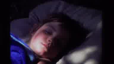 California USA (1981): Child Sleeping Than Sitting On A Blanket Playing With