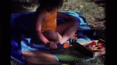 California USA (1981): Little Kid Playing Outside With A Toy On A Hot Summer Day