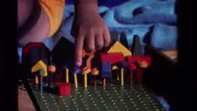 California USA (1981): Little Girl Playing With Blocks Outside On A Blanket