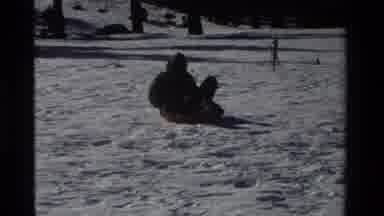 California USA (1981): Riding A Plastic Board On The Snow With The Family