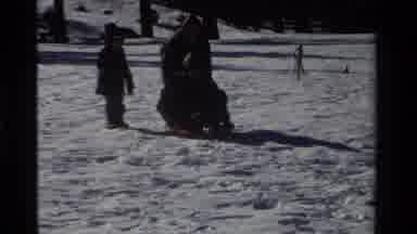 California USA (1981): Person Helping Man On Sled To Get Started Going Down A