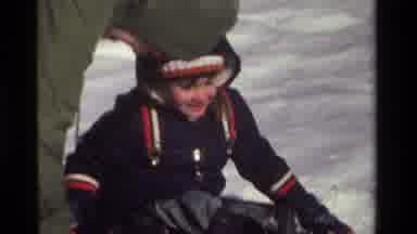 California USA (1981): Young Female Child Playing In The Snow With An Adult
