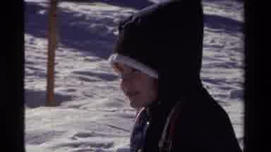 California USA (1981): Two Young Boys In Beanies Sled Down A Snowy Hill