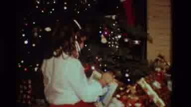 California USA (1984): A Young Girl Opening Christmas Gifts In 1980