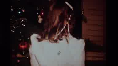 California USA (1984): A Young Girl Is Opening Her Christmas Presents Near The