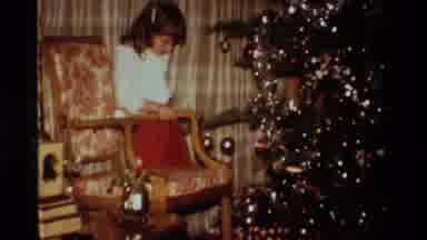 California USA (1984): Young Girl Opening Gifts Under A Christmas Tree On