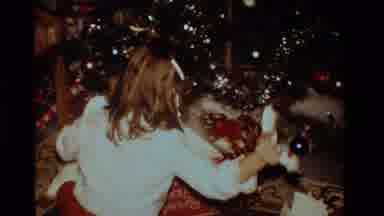 California USA (1984): Young Girl Opening A Christmas Present Beneath The