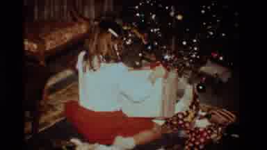 California USA (1984): Young Girl Opening Christmas Presents