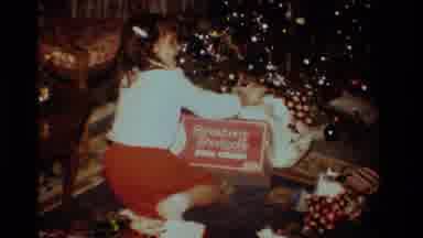 California USA (1984): Young Girl Excitedly Opens Christmas Present