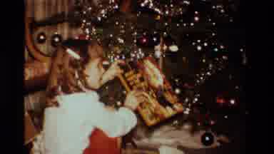 California USA (1984): Young Girl Opening Christmas Presents Near The Christmas