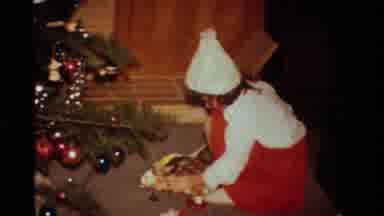 California USA (1984): A Young Girl In Red Is Opening Her Presents On Christmas